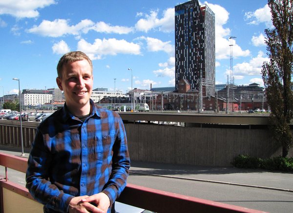 CEO Toni Hopponen is admiring Tampere’s newest landmark, the Torni hotel, from the balcony of Flockler’s Tampere office.​​